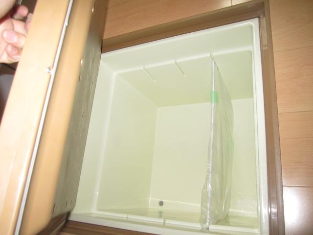 Kitchen. It is a photograph of the under-floor storage