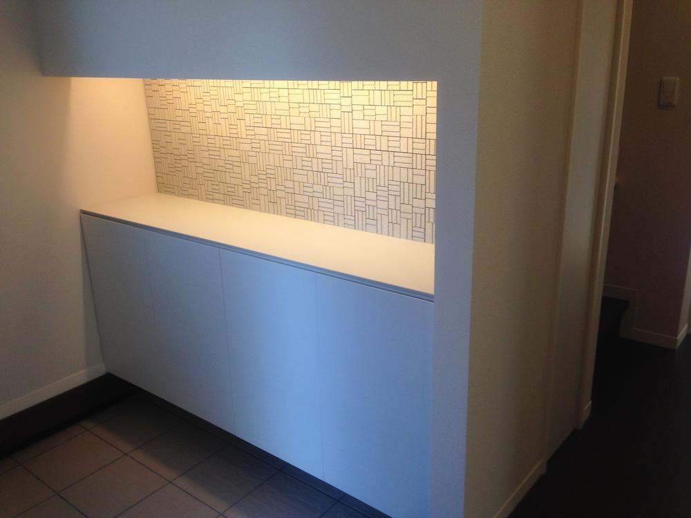 Entrance. Elegant foyer storage decorated with tiles on the wall