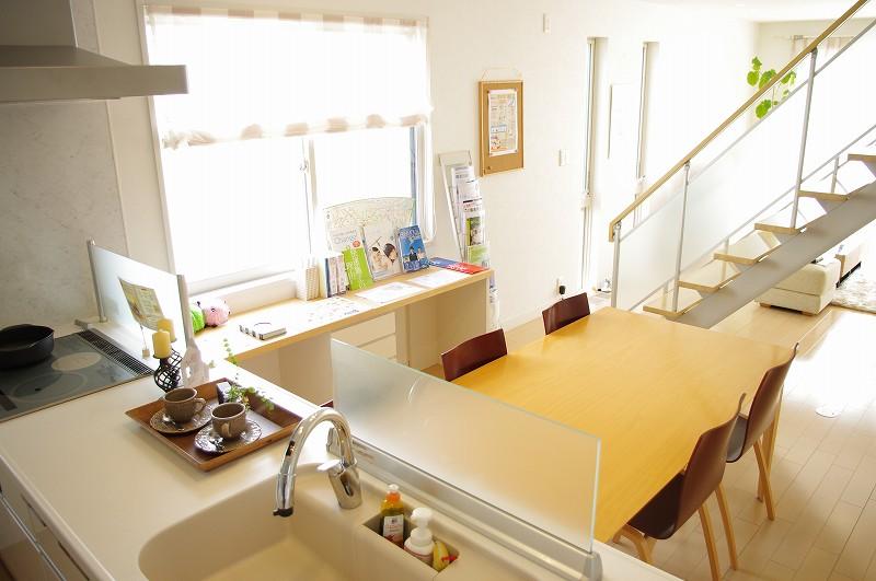 Model house photo. A kitchen and a living room can be seen all