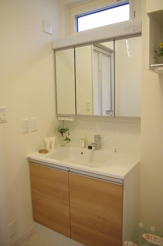 Model house photo. Powder room with a large mirror