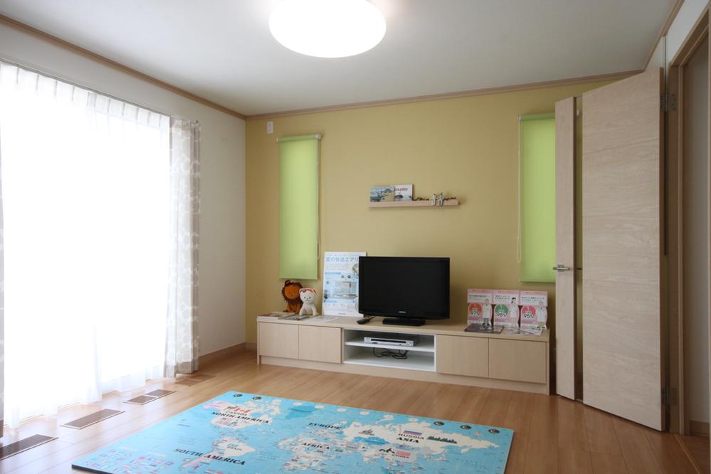 Living. Built-in TV board is housed enhancement. Accent wallpaper of and makes the atmosphere of the room.