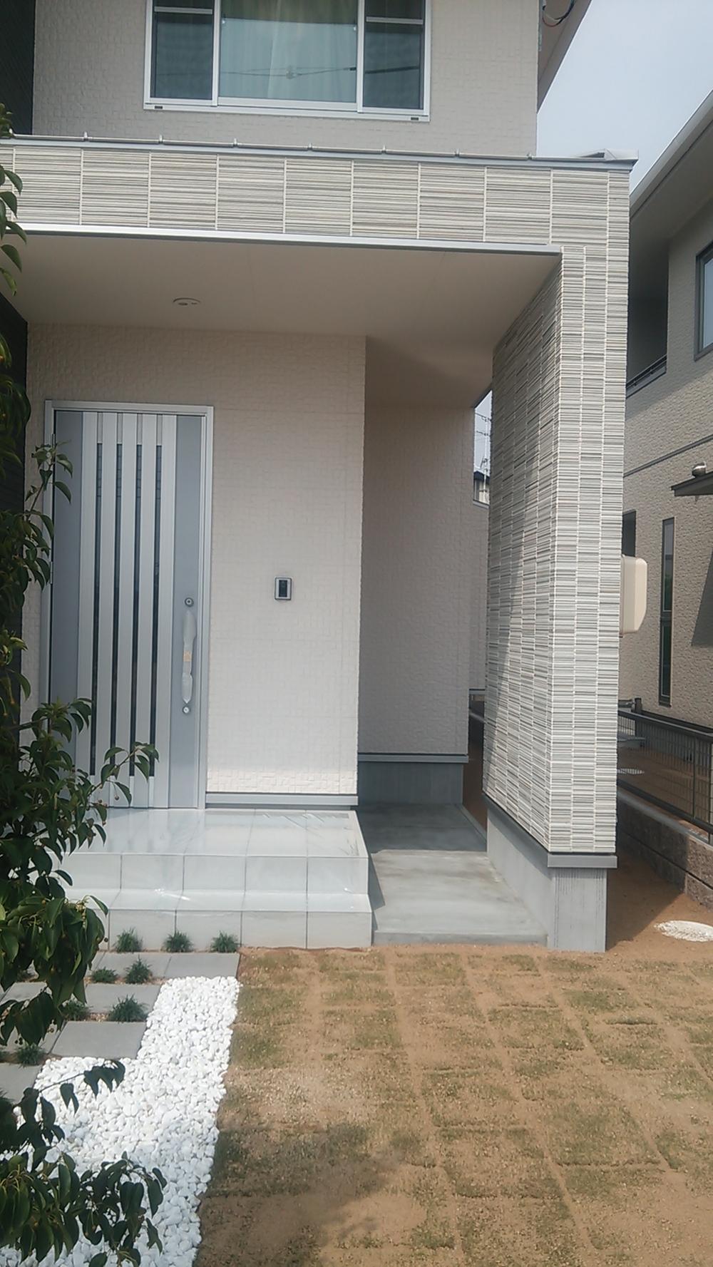 Other. There is dirt floor space with a roof to the front door next to.