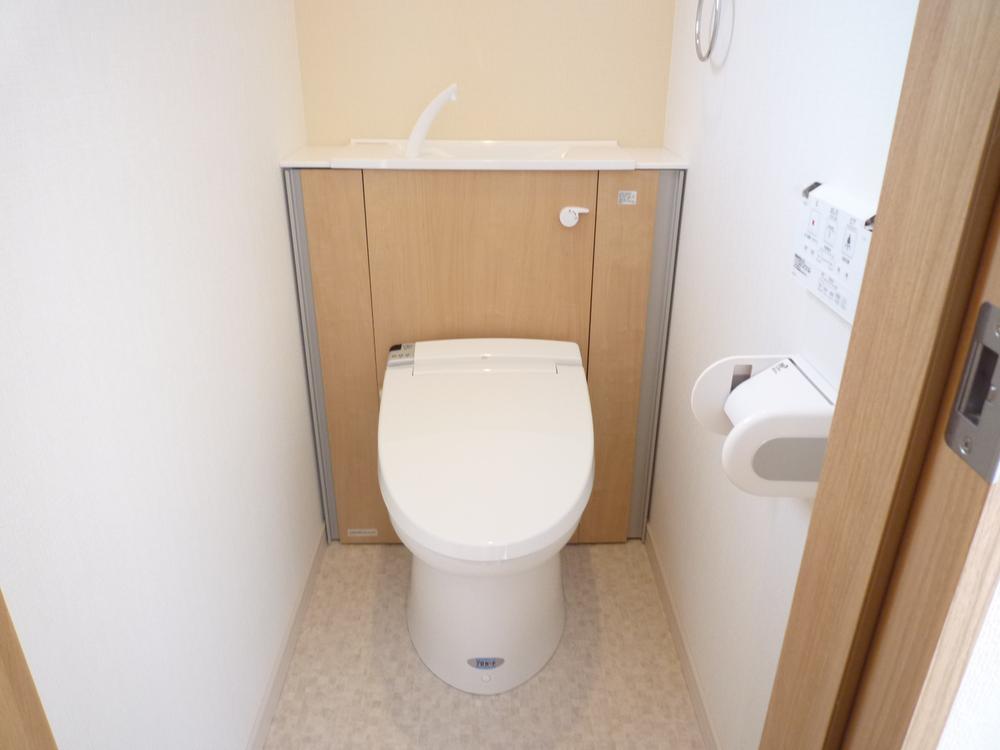 Toilet. With refreshing housed in toilet