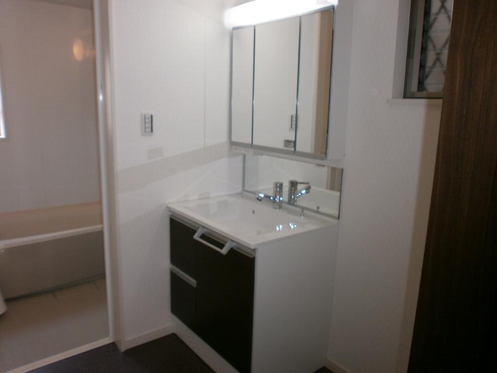 Wash basin, toilet. It is the washroom