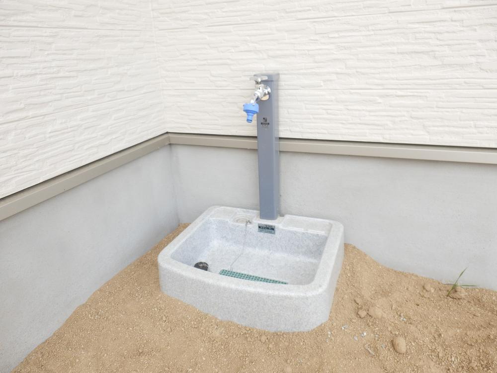 Parking lot. It is water that is in the parking lot!