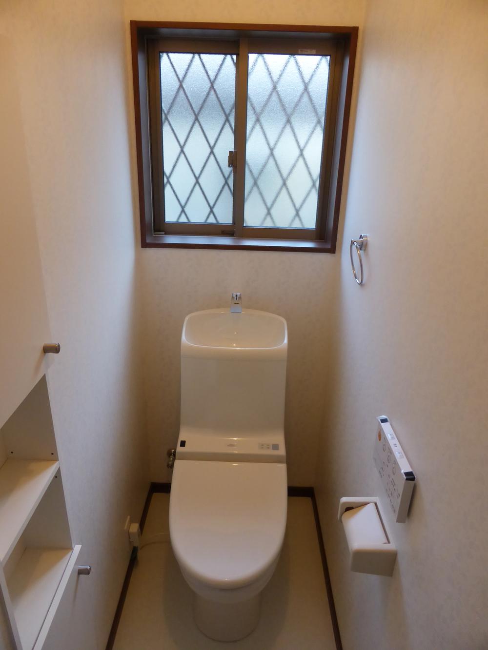 Toilet. Stock also with definitive storage rack toilet