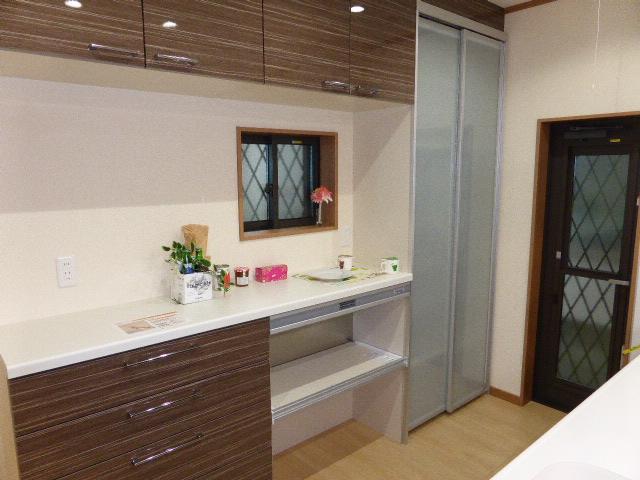 Kitchen. Kitchen with a back door. Fashionable at large with storage of the kitchen and all together in the back