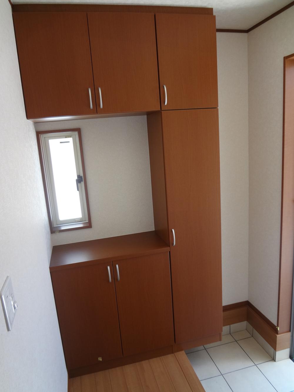 Entrance. There are a number of shoe box storage.