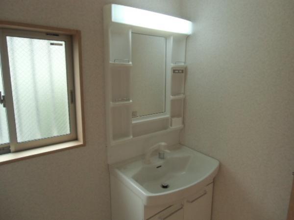 Wash basin, toilet. Dressed in smooth wash room of the room