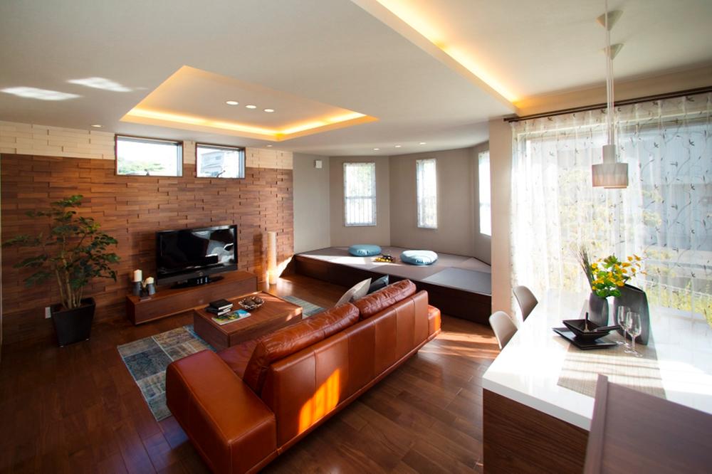 Model house photo.  [Model house living] Open living. All living room overlooking from the kitchen. Come by inserting the light of Sansan and the sun is from the longitudinal slit window of the front.