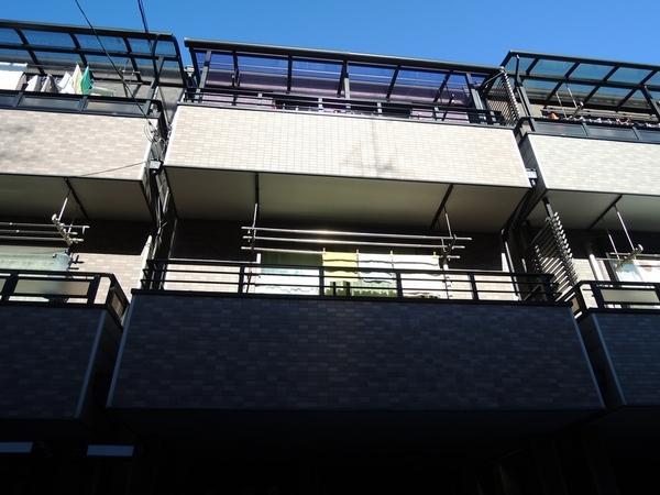 Local appearance photo. South-facing house shine in blue sky. 