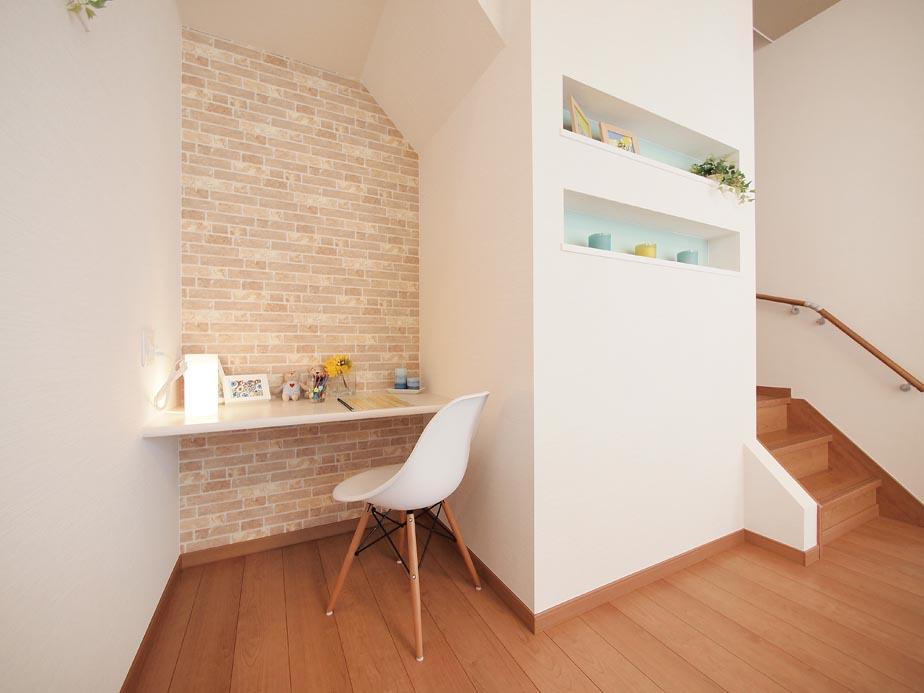 Model house photo. Workspace next to the living room. Because they are created in the space under the stairs breadth of living is intact. 