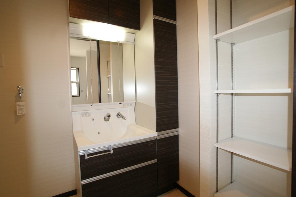 Wash basin, toilet. The wash basin beside we have provided a convenient shelves in the storage lot.