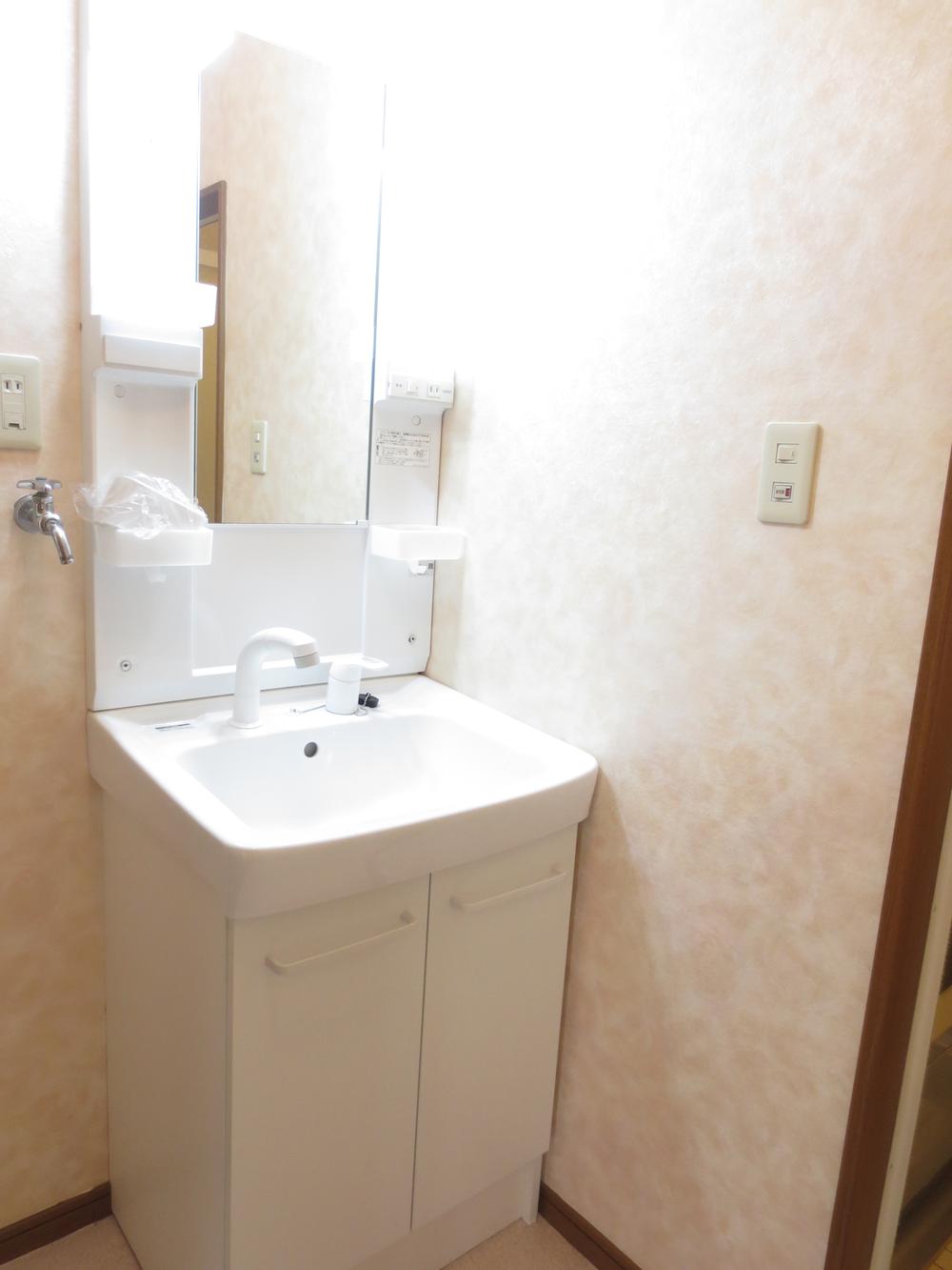 Wash basin, toilet. It is a washroom with a clean