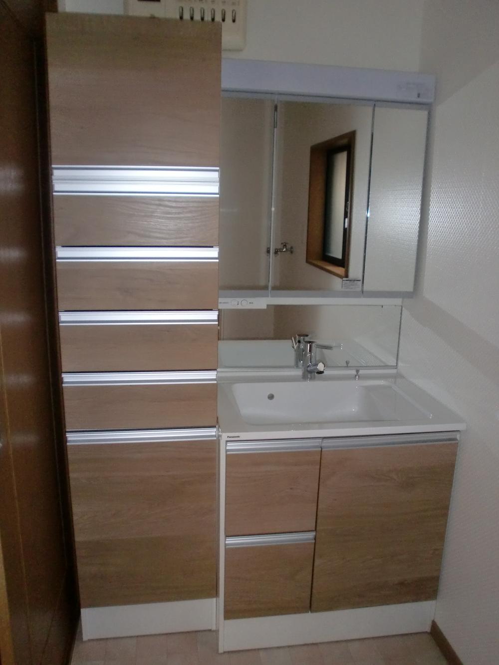 Wash basin, toilet. Storage is abundant basin space. 