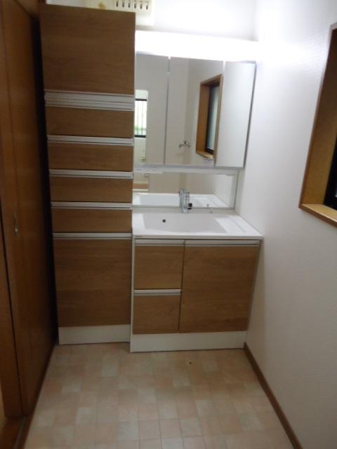 Wash basin, toilet. Wash basin had made with towels Shelves