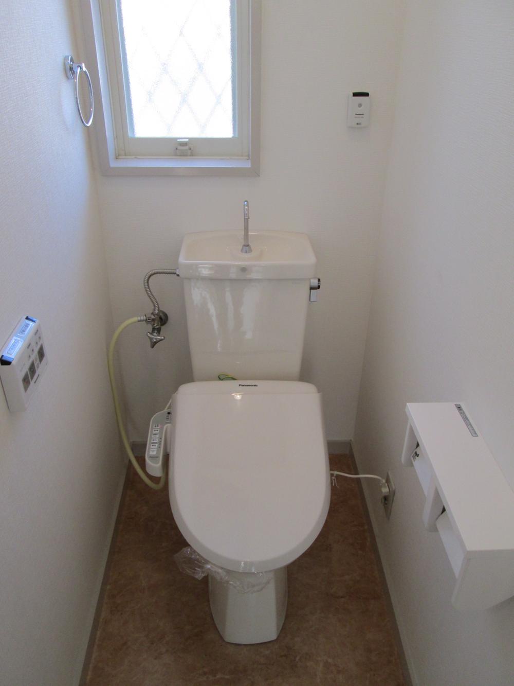 Toilet. Restroom where the light is plugged.