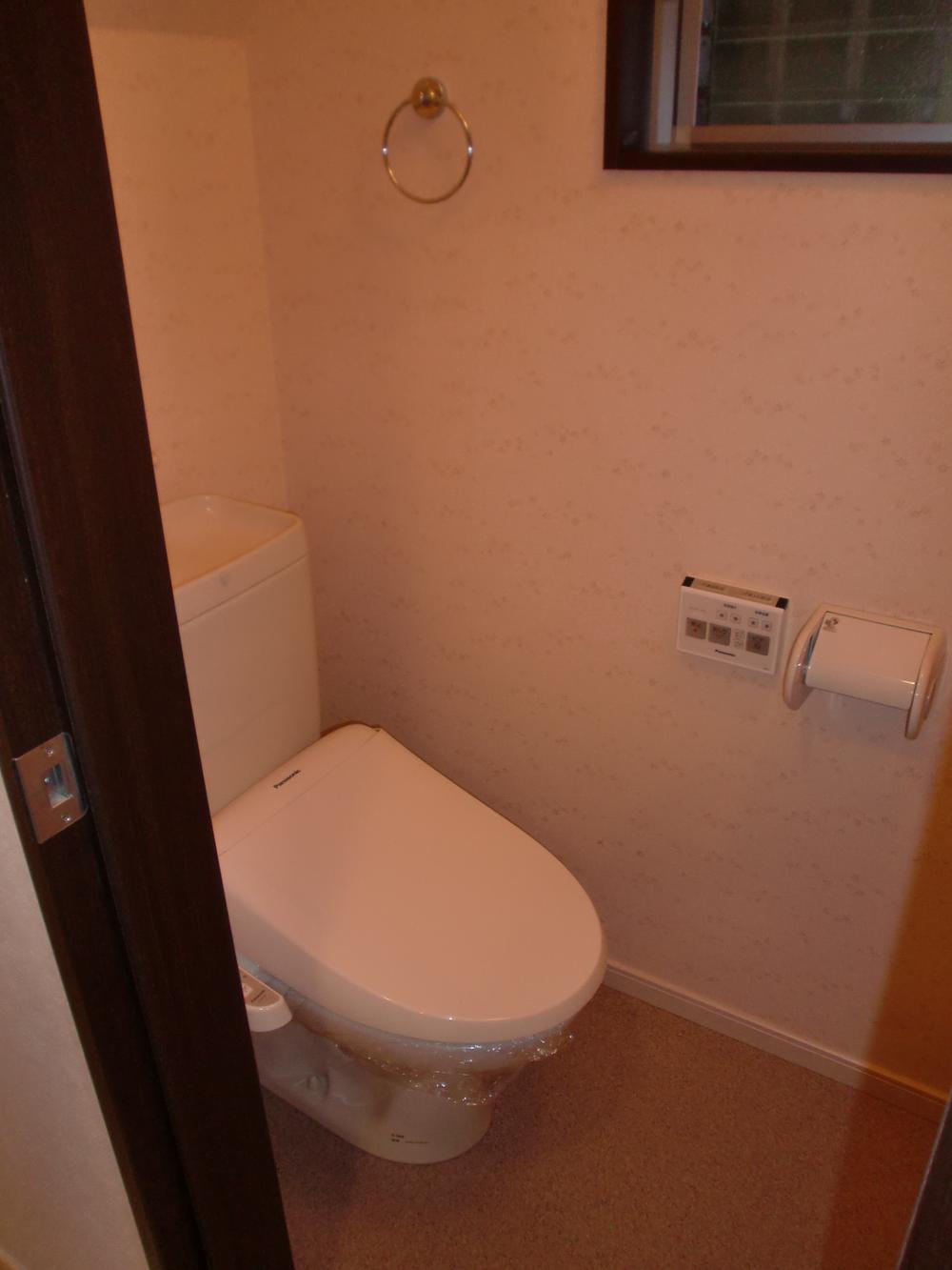 Toilet. Restroom with There is also a clean window.