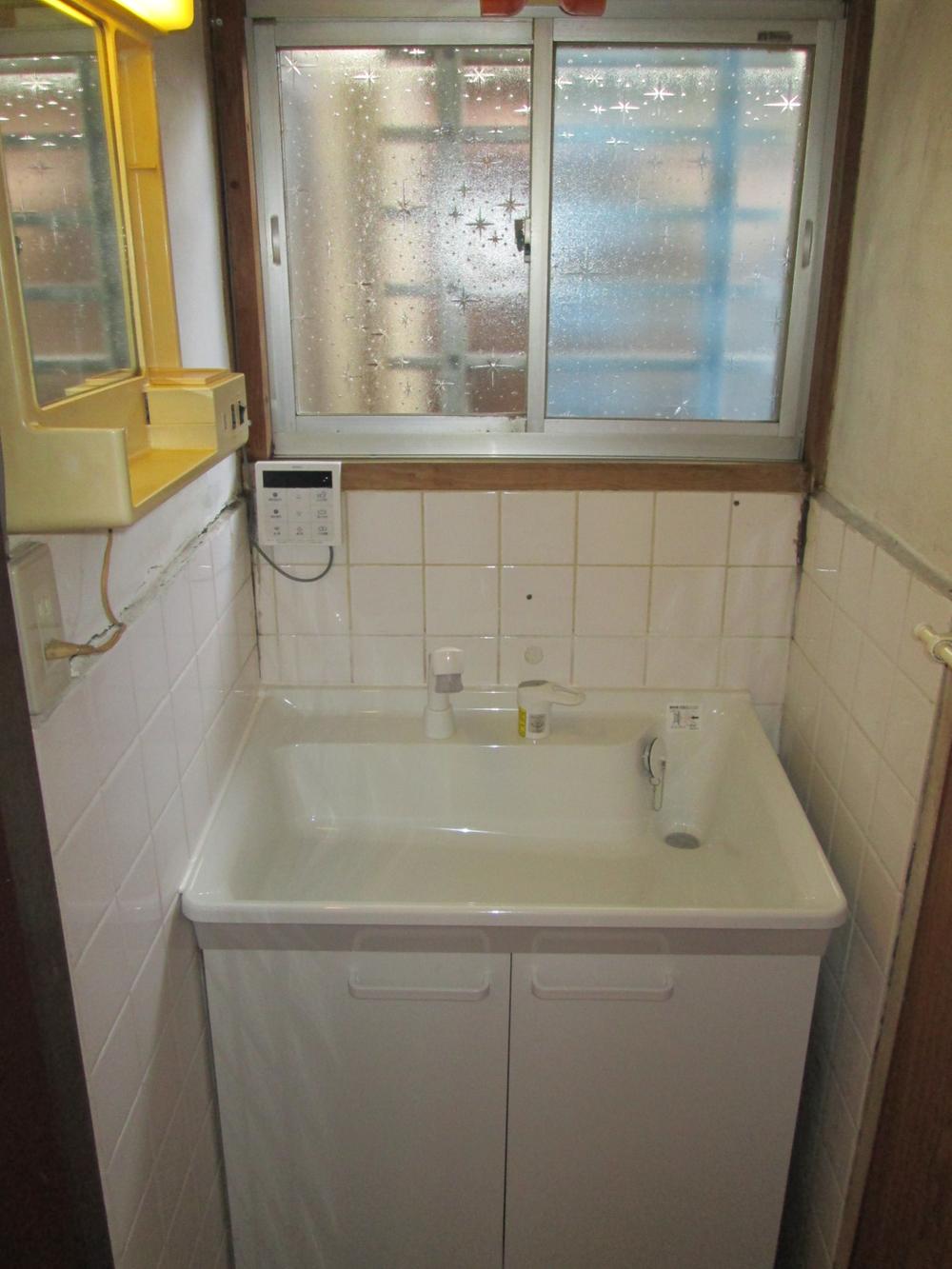 Wash basin, toilet. Bright washroom.