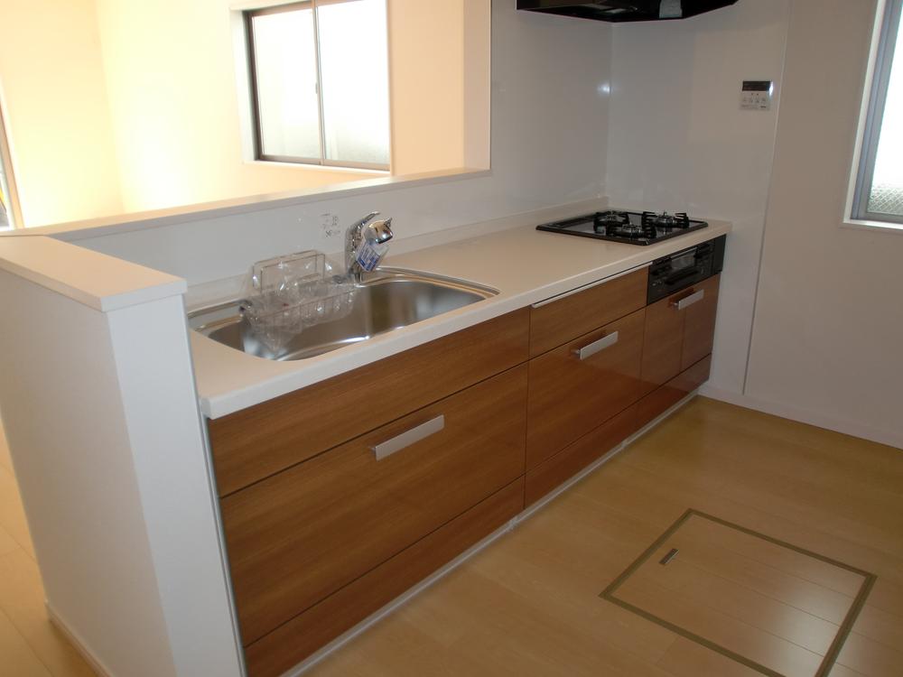 Kitchen. It is bright because of the open-counter kitchen adopted