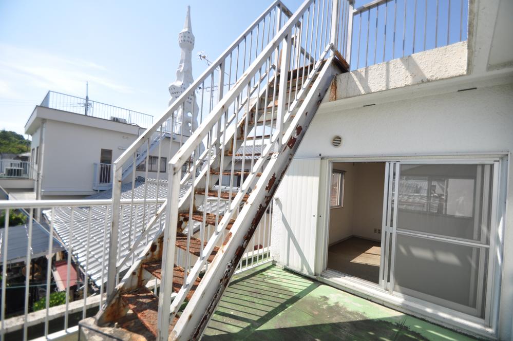 Balcony. Stairs leading to the roof