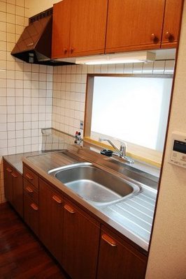 Kitchen. It is sink a big counter kitchen.