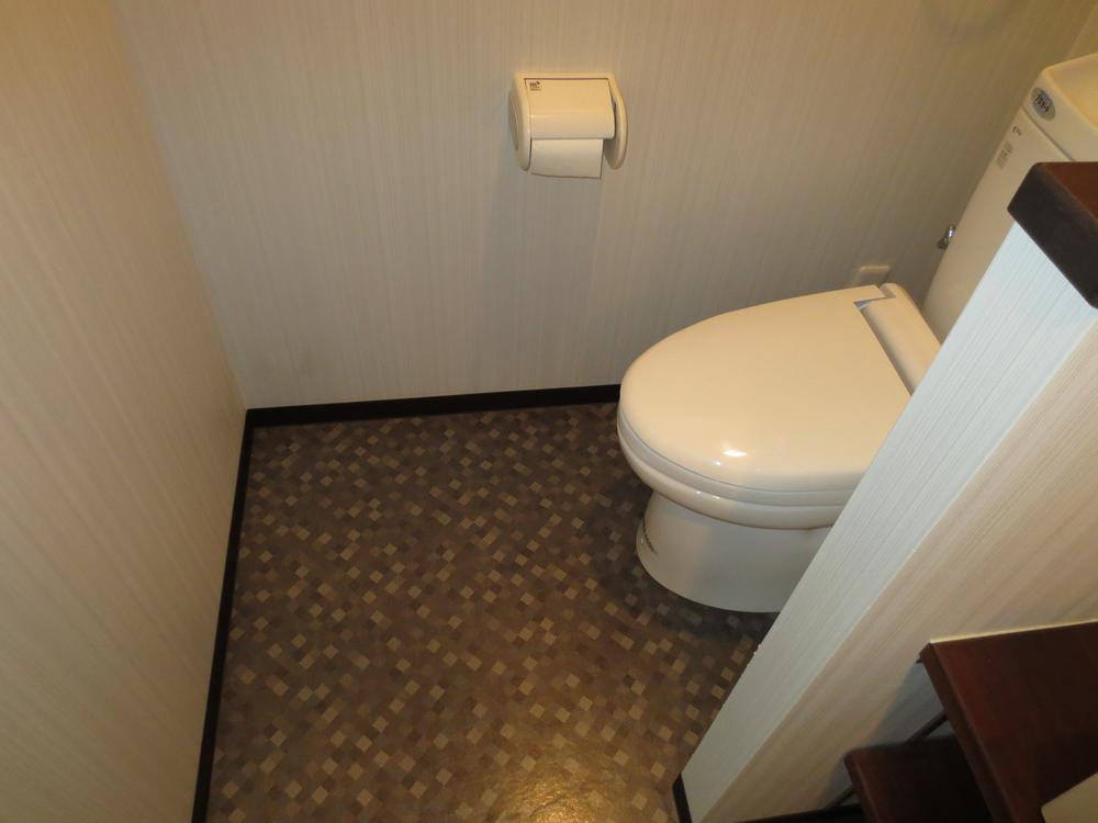 Toilet. It is a photograph of the bathroom next to.