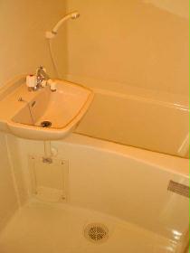 Bath. It is pure white the bathroom equipped with a wash basin.