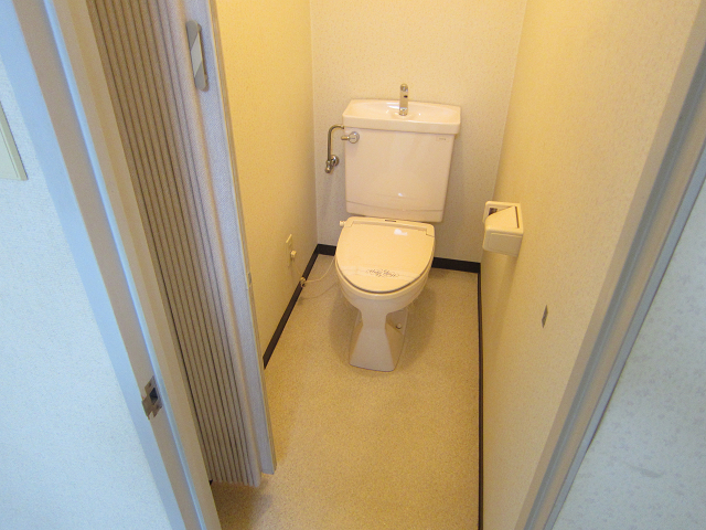 Toilet. It has also attached towel hanger