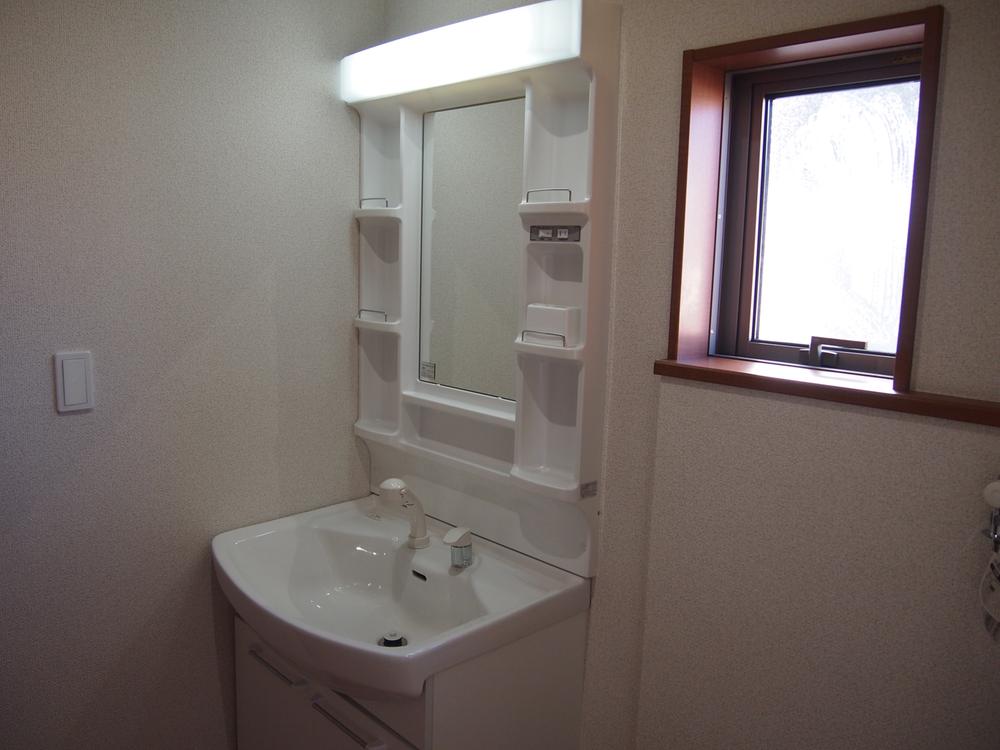 Wash basin, toilet. It is the washroom.