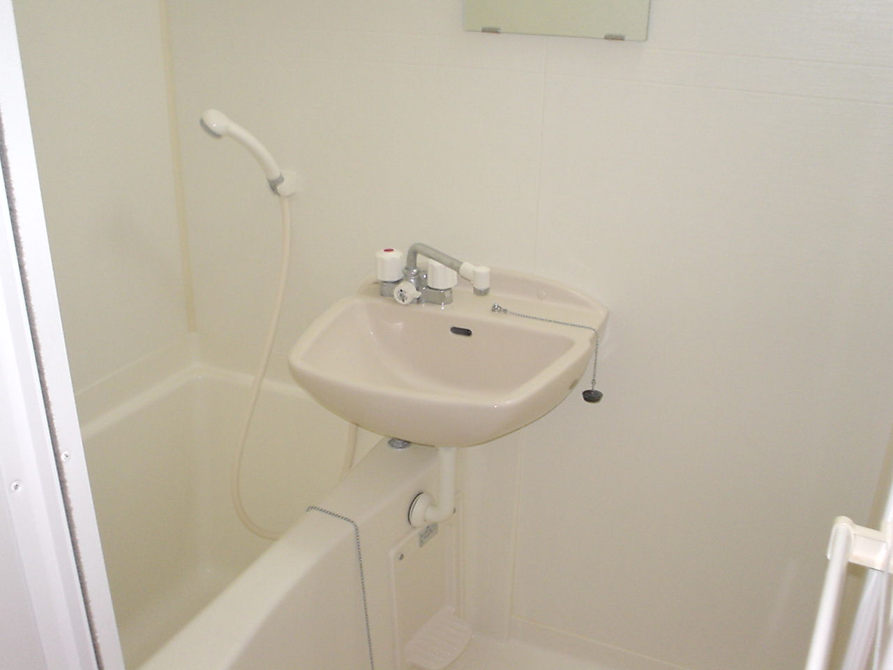 Bath. It is a bathroom with a shower. It is with a bathroom ventilation dryer.