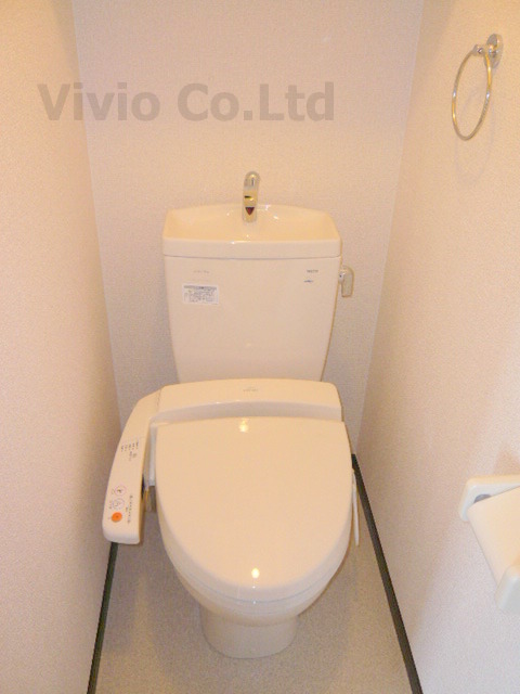 Toilet. It is with warm water washing toilet seat.