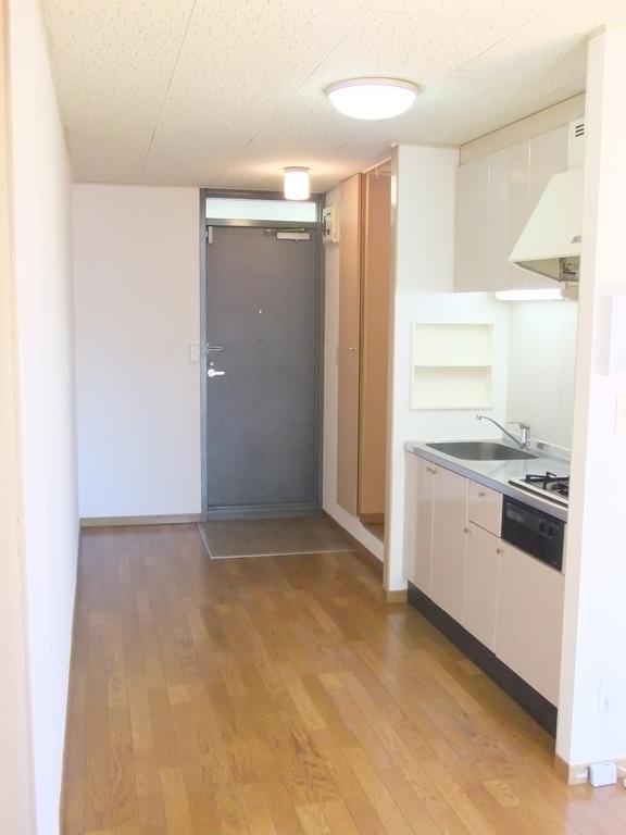 Living and room. There is also a room without furniture.