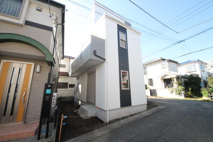 Local appearance photo. Corner lot is the property. 