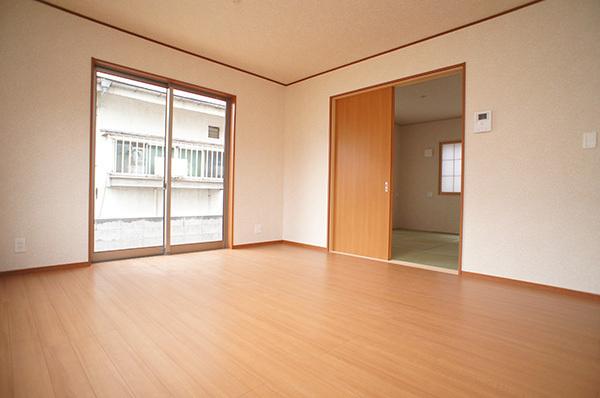 Living. Plenty of sunshine from large windows shine in