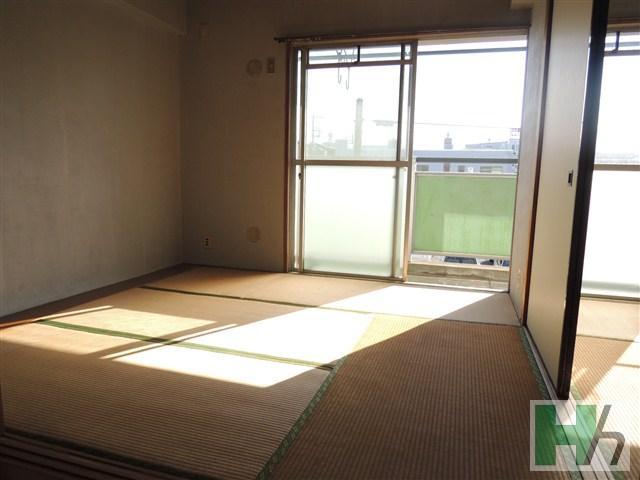 Other room space. It is a bright room contains the sunlight from the window. 