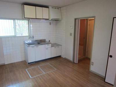 Living and room. There is a window in the kitchen next to