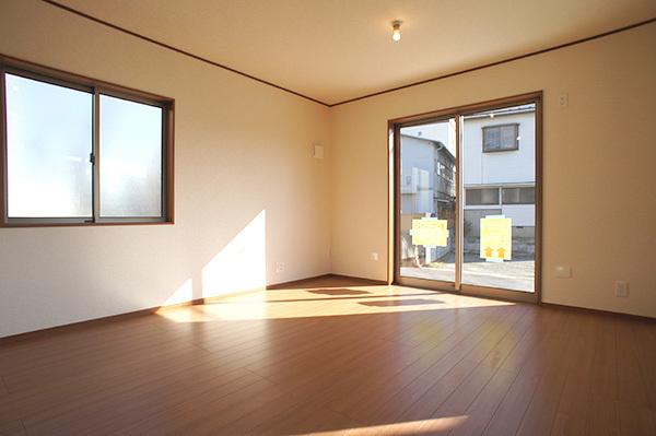 Living. Plenty of sunshine from large windows shine in