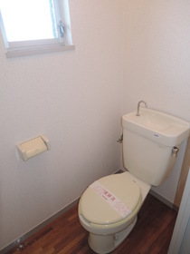 Toilet. There is a window in the toilet