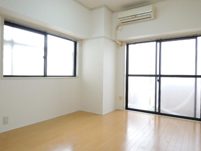 Living and room. In the corner room, There is a window. 