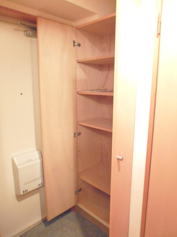 Entrance. Cupboard to top