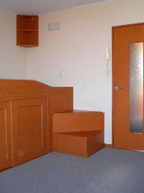 Living and room. Carpet flooring and brown furniture.