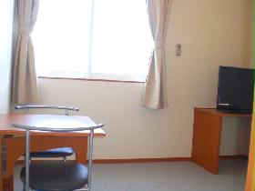 Living and room. Daylight windows and a folding table. 