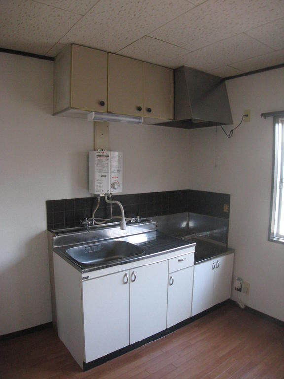 Kitchen. There is a window next to the kitchen.