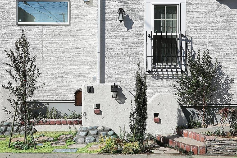 Model house photo. Colorful trees and natural materials exterior design