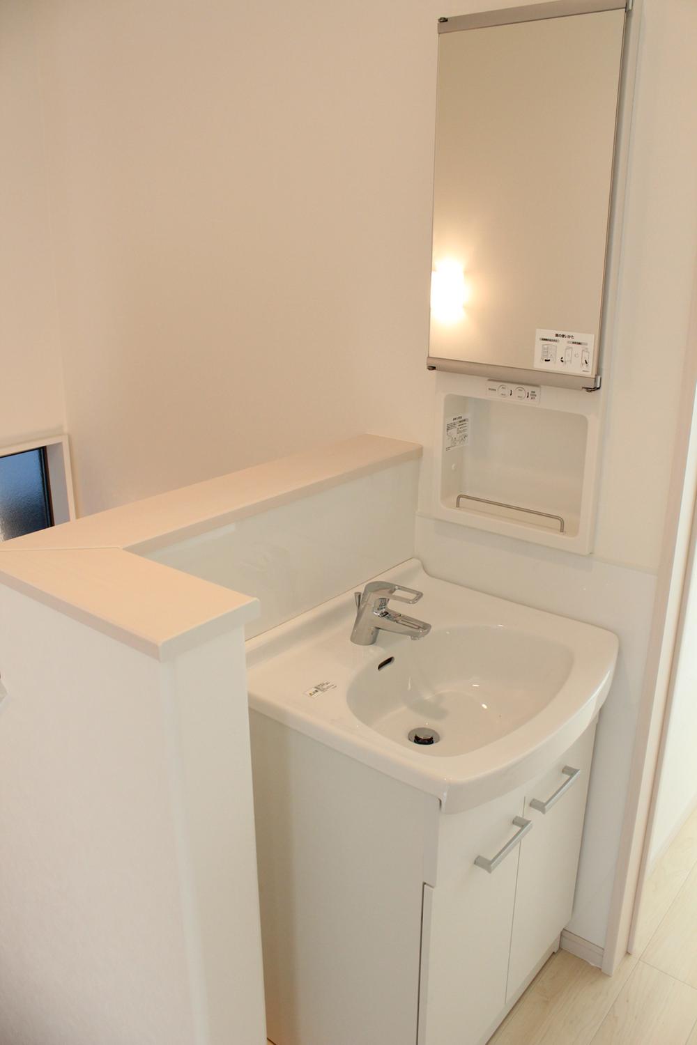 Wash basin, toilet. It is with a wash basin also on the second floor