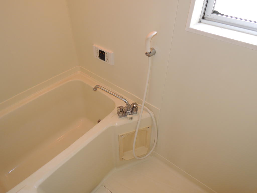 Bath. Bright bathroom with a window. 