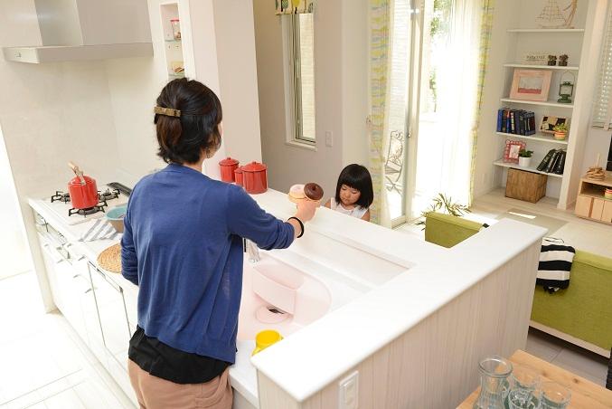 Model house photo. Bright and airy kitchen is also capable of interaction with children while doing housework