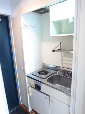 Kitchen. It is a mini kitchen with a refrigerator