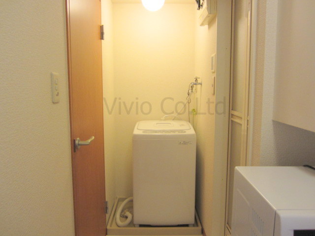 Toilet. Laundry Area is located in the room.